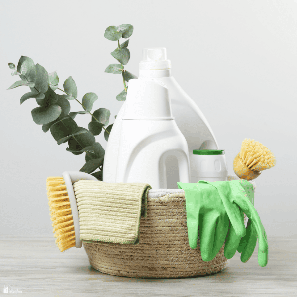 A basket of cleaning supplies features reusable tools and household products that support a cleaner and healthier home.
