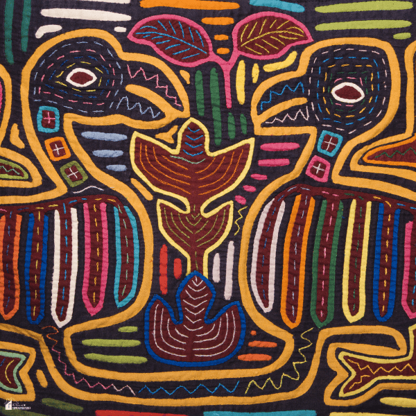 Colorful Aboriginal-style textile artwork featuring two stylized birds surrounded by bold geometric patterns, leaves, and detailed stitching.