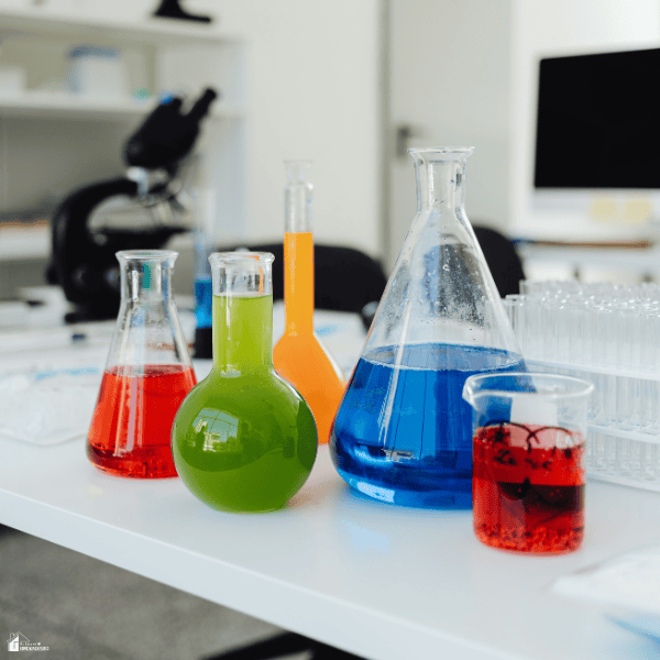Colorful liquids in laboratory glassware represent a kitchen chemistry experiment using safe, hands-on science activities.