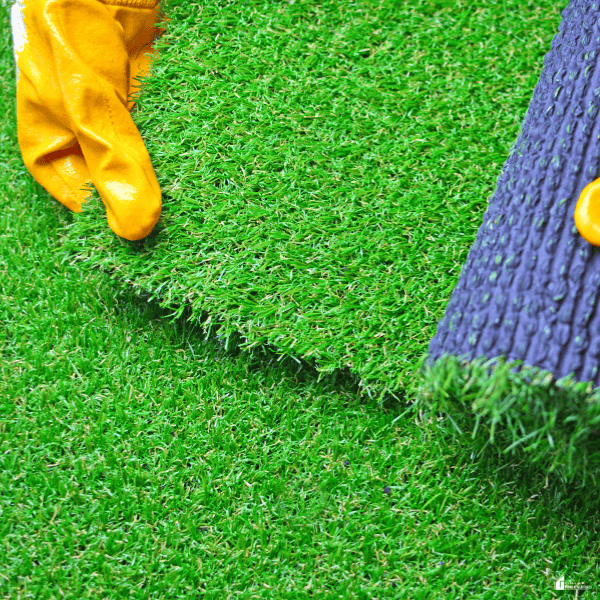 Artificial grass installed around a tree provides a low-upkeep backyard feature that reduces mowing, watering, and routine lawn care.