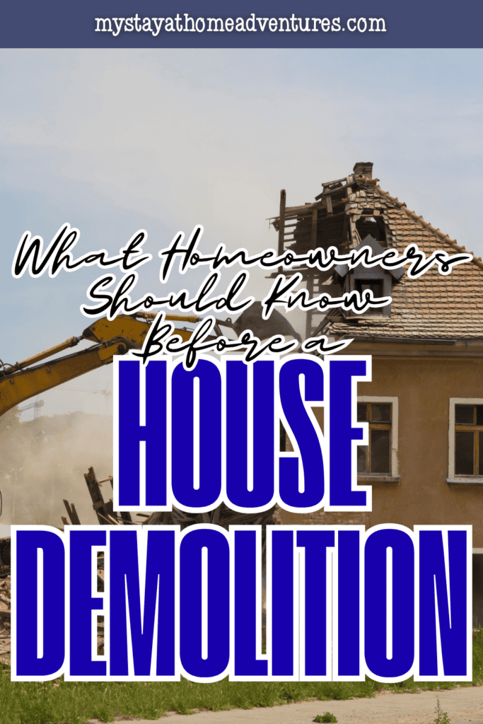 Excavator demolishing an older house as dust and debris surround the structure during a residential demolition project.