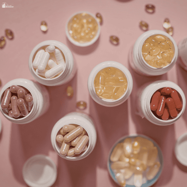 Open bottles filled with assorted capsules and softgels arranged together, representing different supplement options a busy family may consider for daily nutrition.