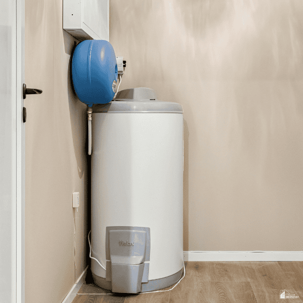 A white water heater and blue expansion tank sit in a utility room where plumbing problems may need attention.