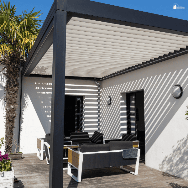 Adjustable roof slats provide flexible shade over a patio sofa.