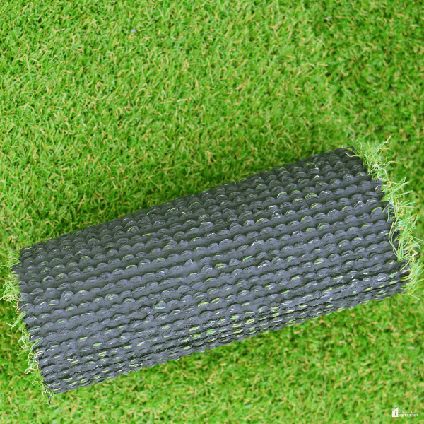 A strip of artificial lawn lies upside down to show its textured backing.
