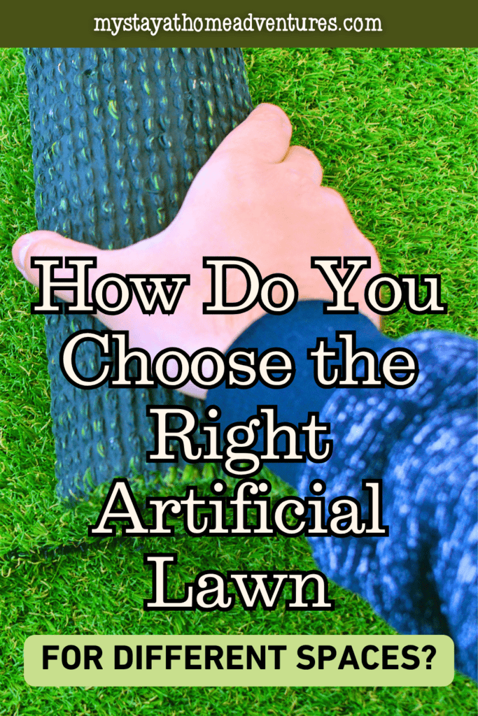 A hand holds a roll of artificial lawn above its green surface.