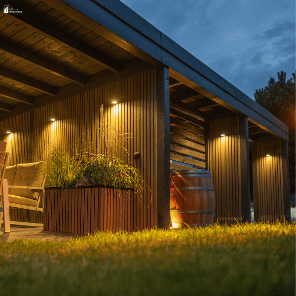 Professional landscape lighting installed around a covered patio, showing the type of outdoor illumination an experienced lighting company can provide.