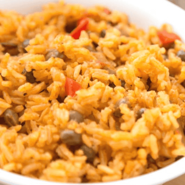 Instant Pot Arroz con Gandules: A close-up shows golden rice mixed with pigeon peas and pieces of red pepper.