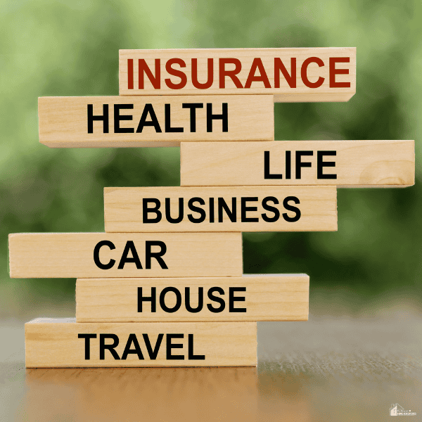 Stacked wooden blocks represent coverage options that may apply after a rental car accident during a vacation.