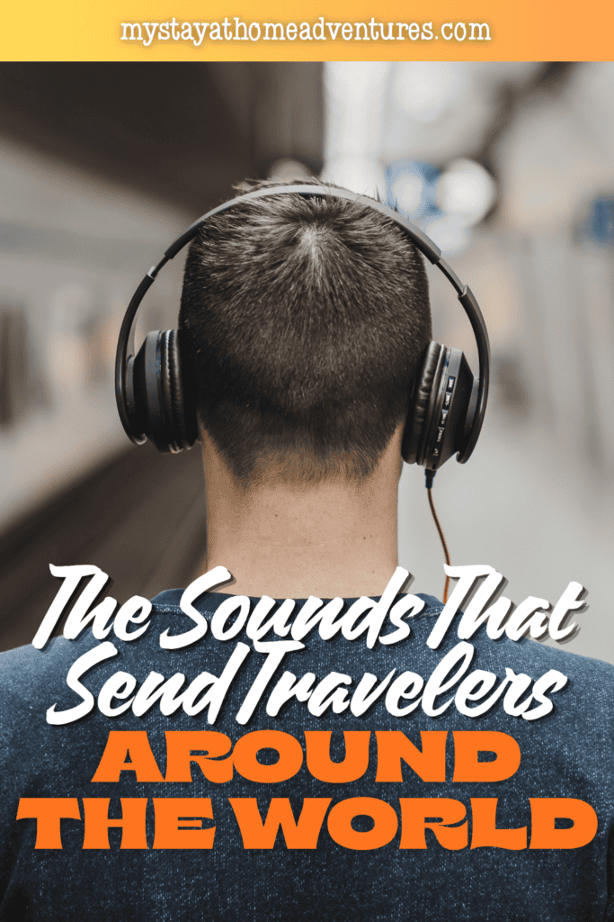 Traveler wearing large headphones while listening to sounds in a busy transportation terminal.