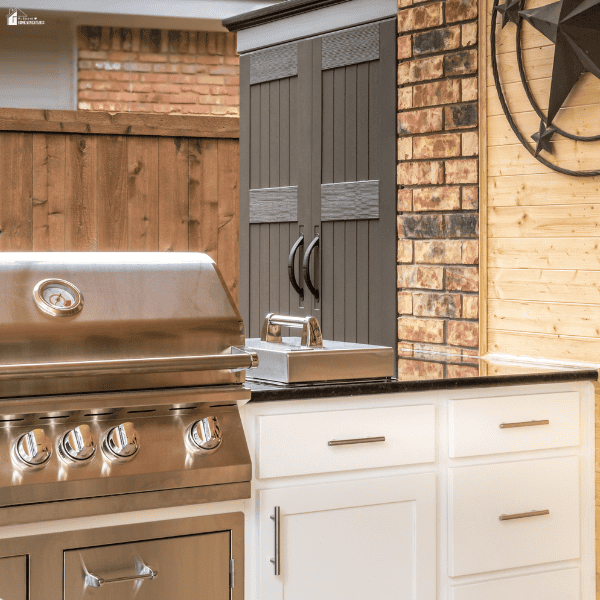 A grill, sink, and storage cabinets form an outdoor kitchen for backyard entertaining.