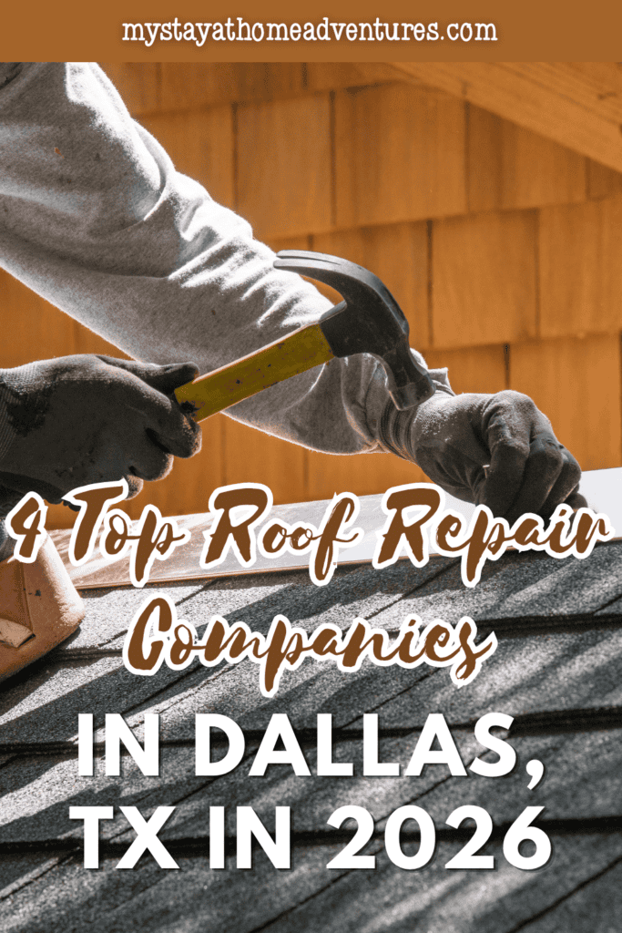 Gloved hands hammer a nail into metal flashing along grey shingles during roof repair.
