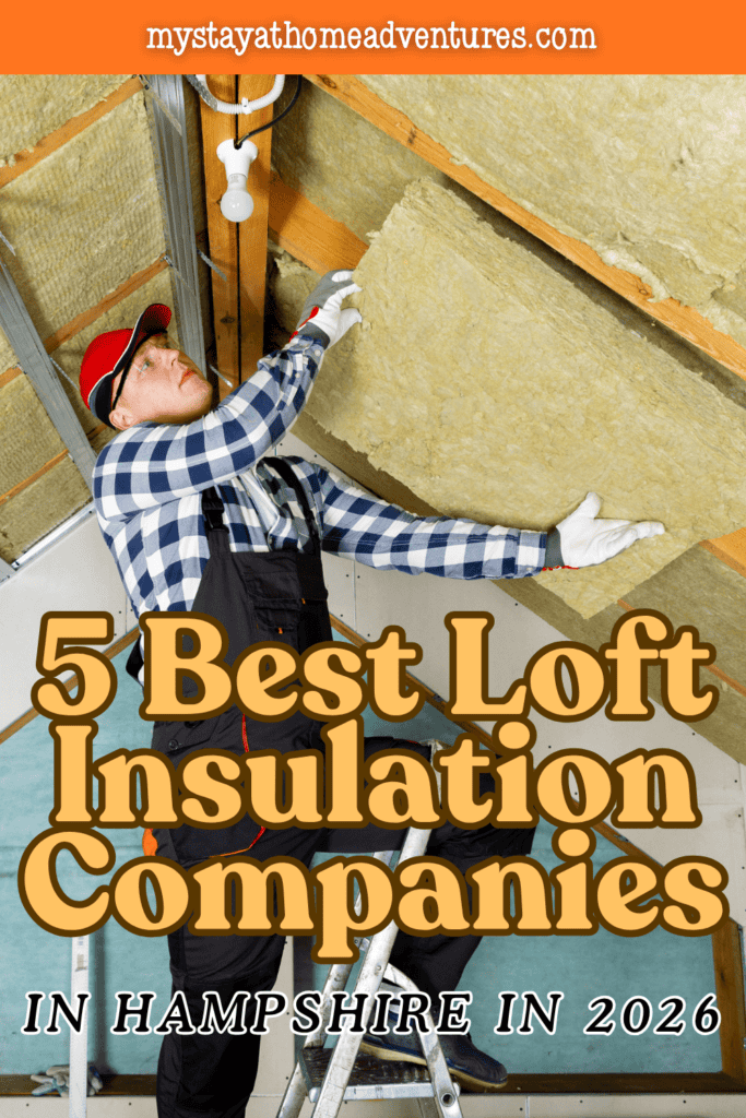 A worker on a stepladder positions a thick mineral wool slab between sloping roof rafters.