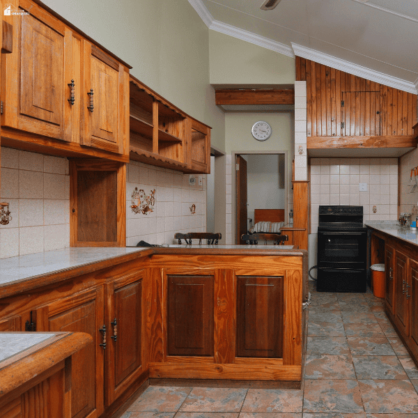 A traditional kitchen with wooden cabinets and patterned tiles illustrates a space homeowners may ask renovation companies to update.