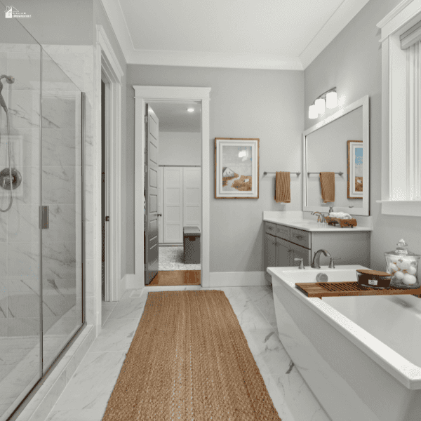 A bathroom with a glass shower, freestanding bathtub, and grey vanity offers design inspiration for homeowners comparing renovation companies.