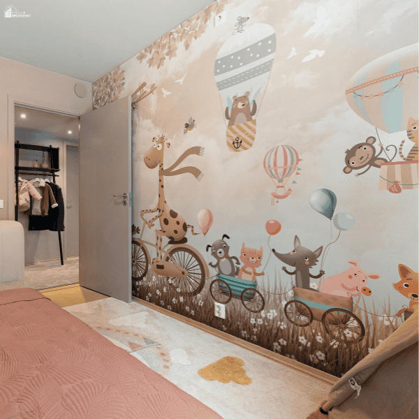 Baby wallpaper featuring pastel animals, bicycles, and hot air balloons complements pink bedding and a patterned rug.