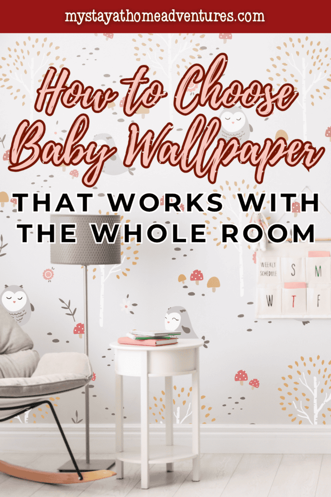 Owl-patterned baby wallpaper in gray, pink, and gold coordinates with a cushioned rocking chair and white side table.