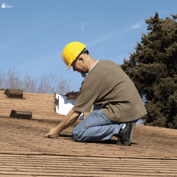 A roof inspector checks shingles and records notes, illustrating a home inspection as part of a hurricane season family safety plan.