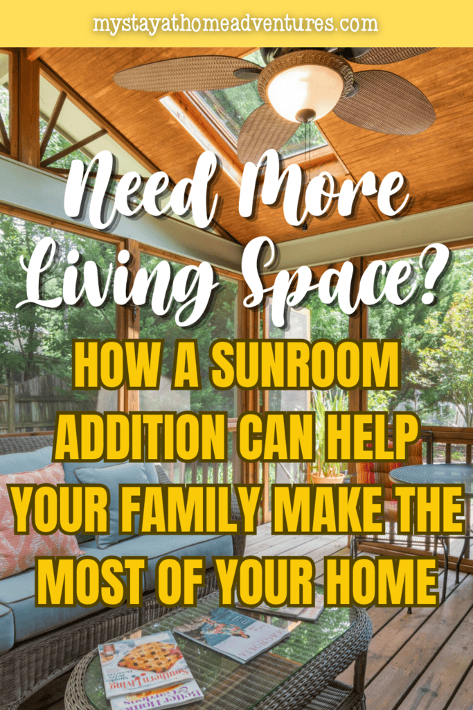 Sunroom with wicker seating, colorful cushions, wooden flooring, skylights, and a ceiling fan overlooking a leafy backyard.