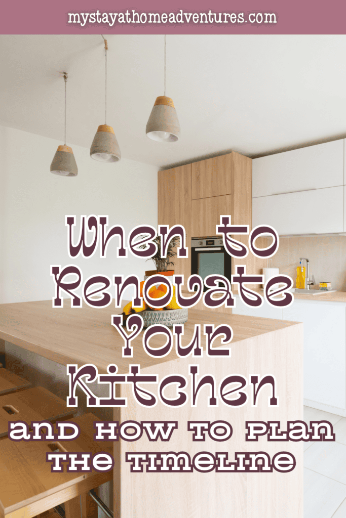 Light wood cabinetry, white cupboards, pendant lights, and a large island with stools create a bright cooking space.